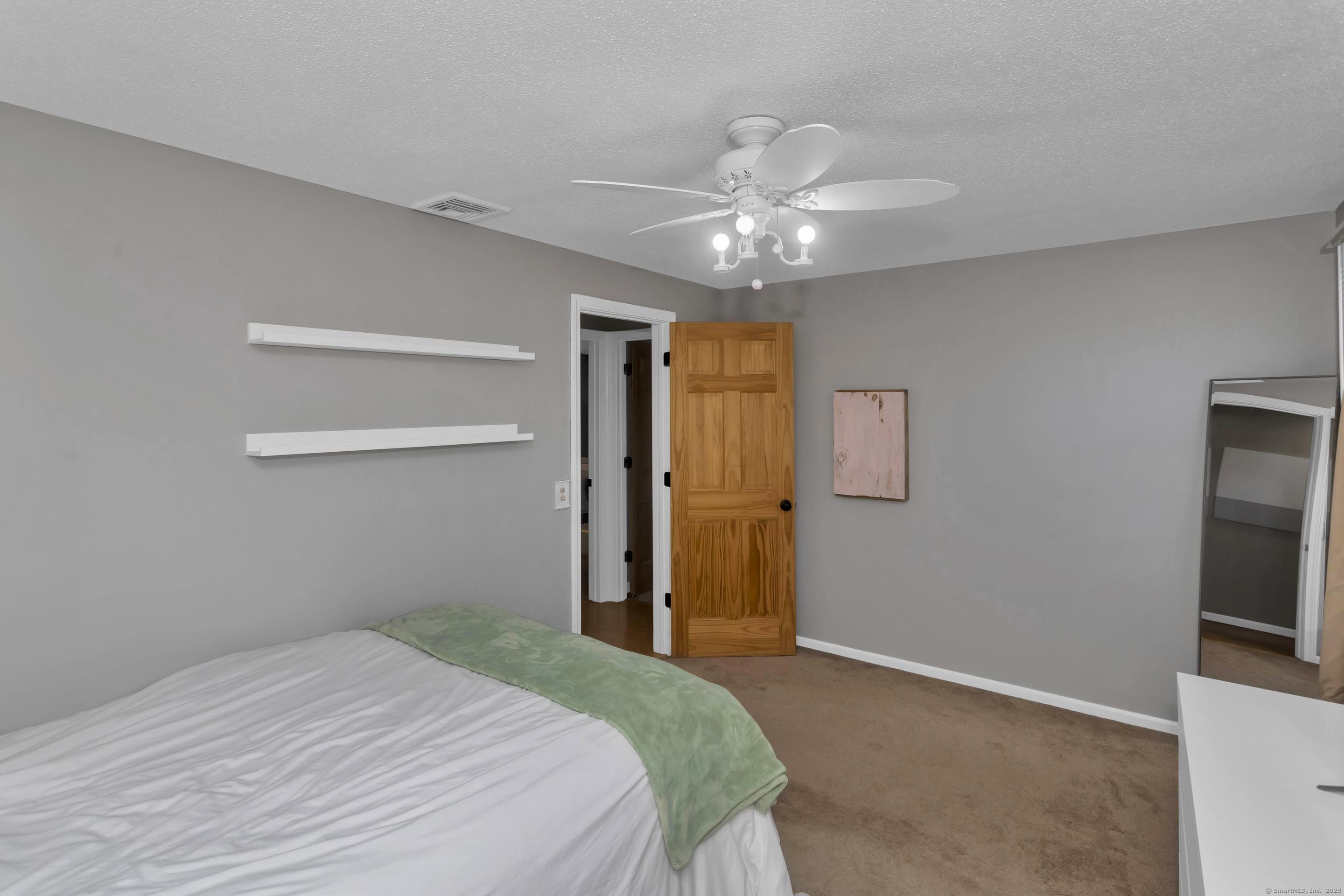 57 Kildeer Lane Suffield, CT 06078 - Photo 36 of 37 a bedroom with a bed and a chandelier