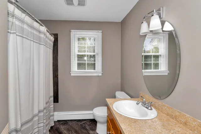 a bathroom with a sink toilet and a mirror