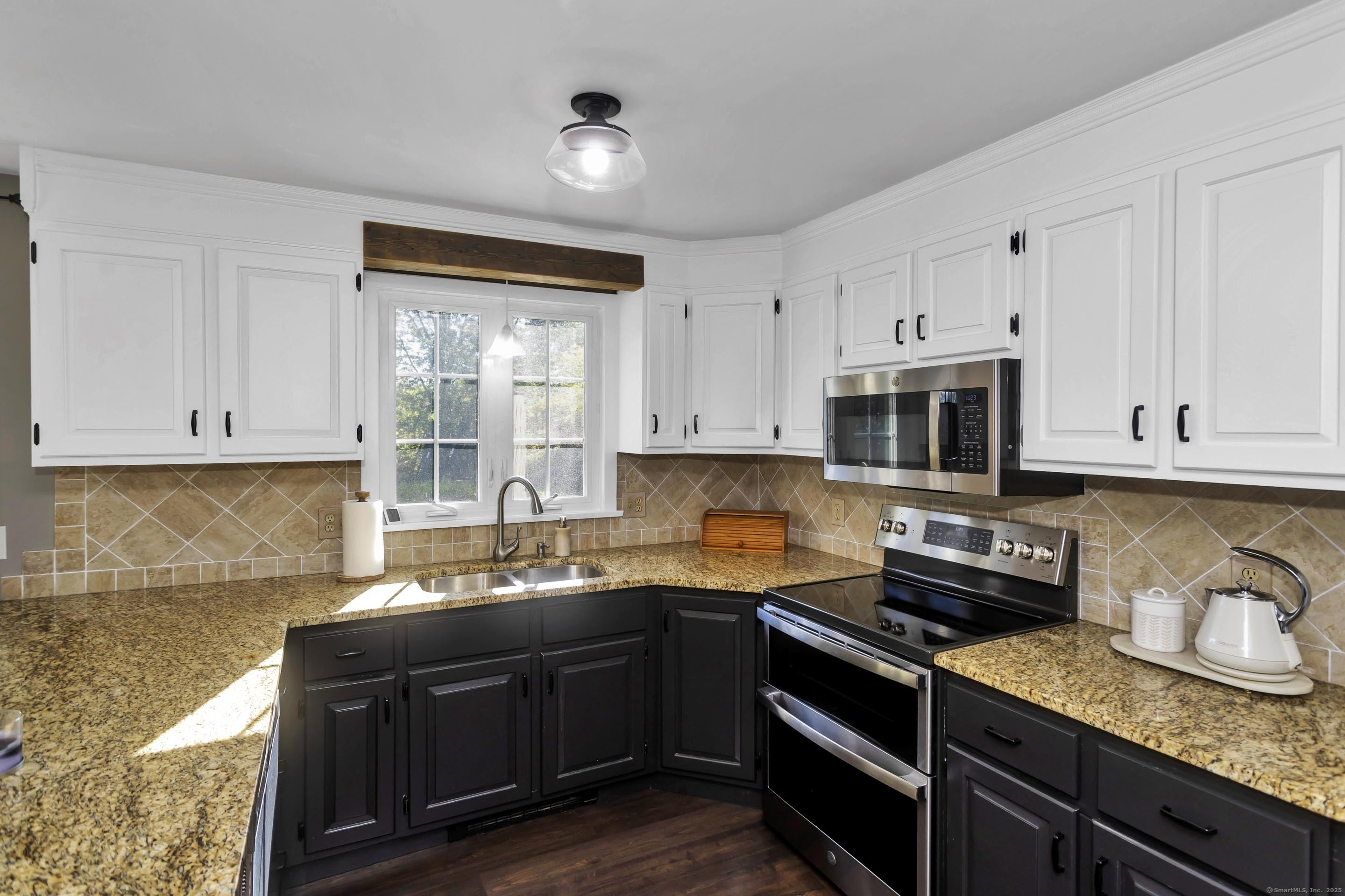57 Kildeer Lane Suffield, CT 06078 - Photo 6 of 37 a kitchen with granite countertop a sink cabinets and stainless steel appliances