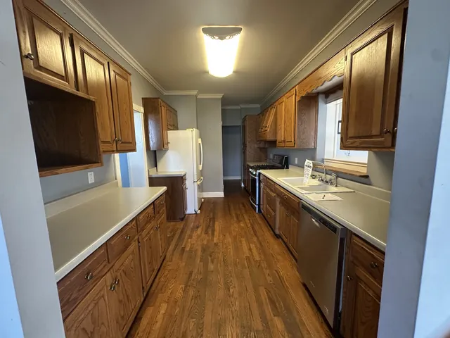 a kitchen with stainless steel appliances a sink stove top oven and cabinets