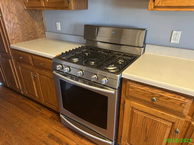 a stove top oven sitting inside of a kitchen