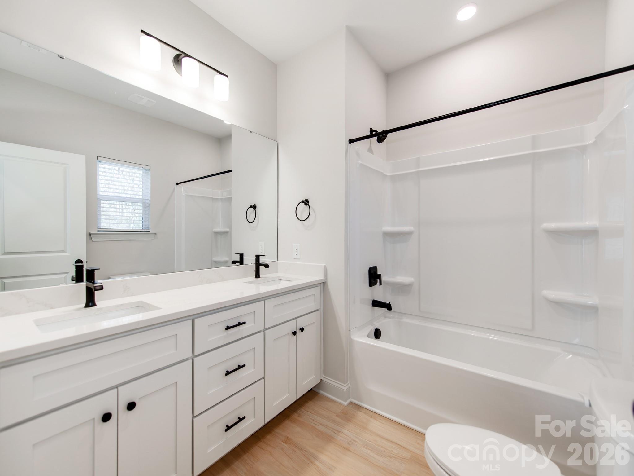 176 Whitetail Road Statesville, NC 28625 - Photo 13 of 23 a bathroom with a granite countertop sink a toilet tub and a shower