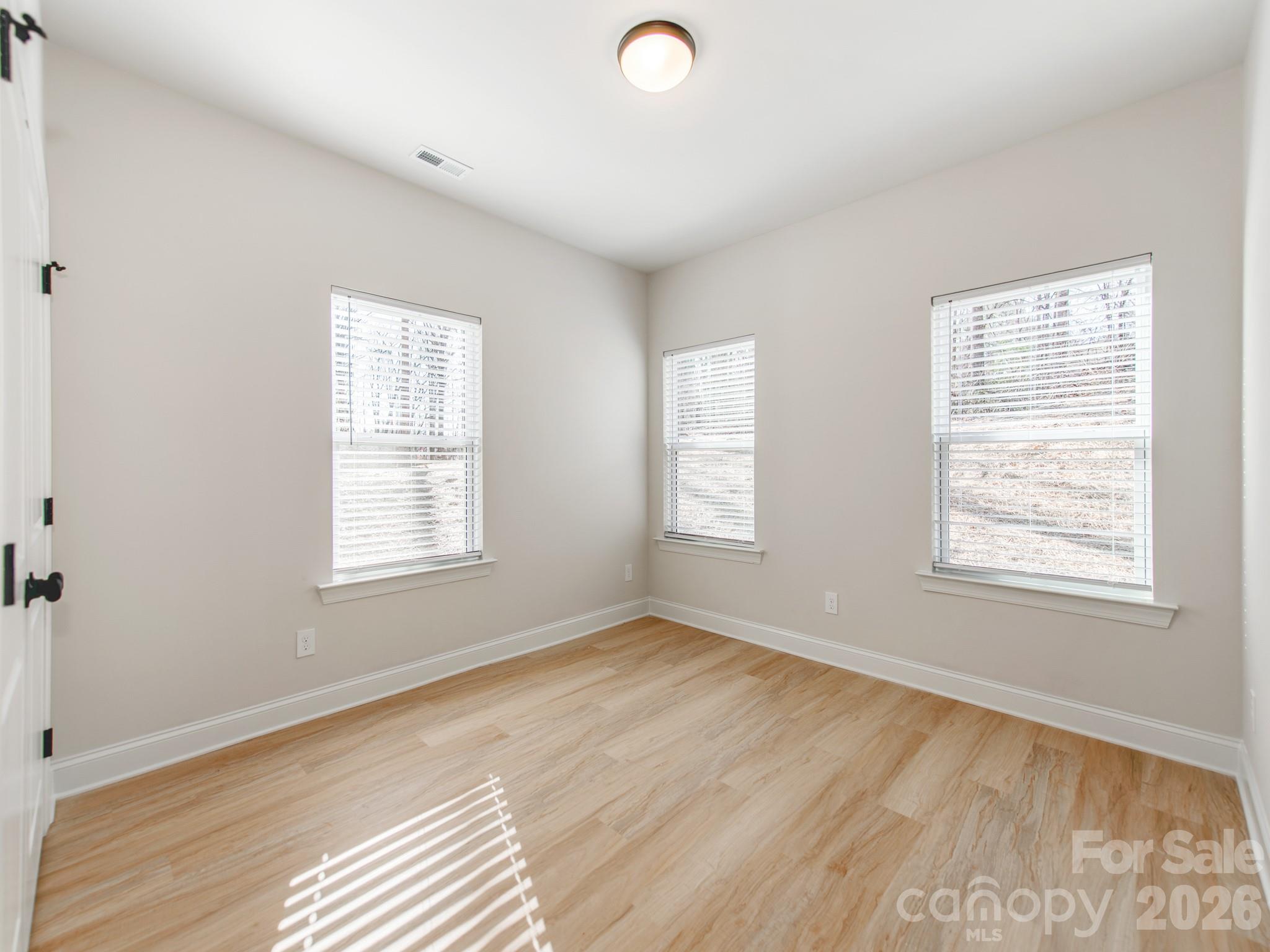 176 Whitetail Road Statesville, NC 28625 - Photo 15 of 23 a view of an empty room with wooden floor and a window
