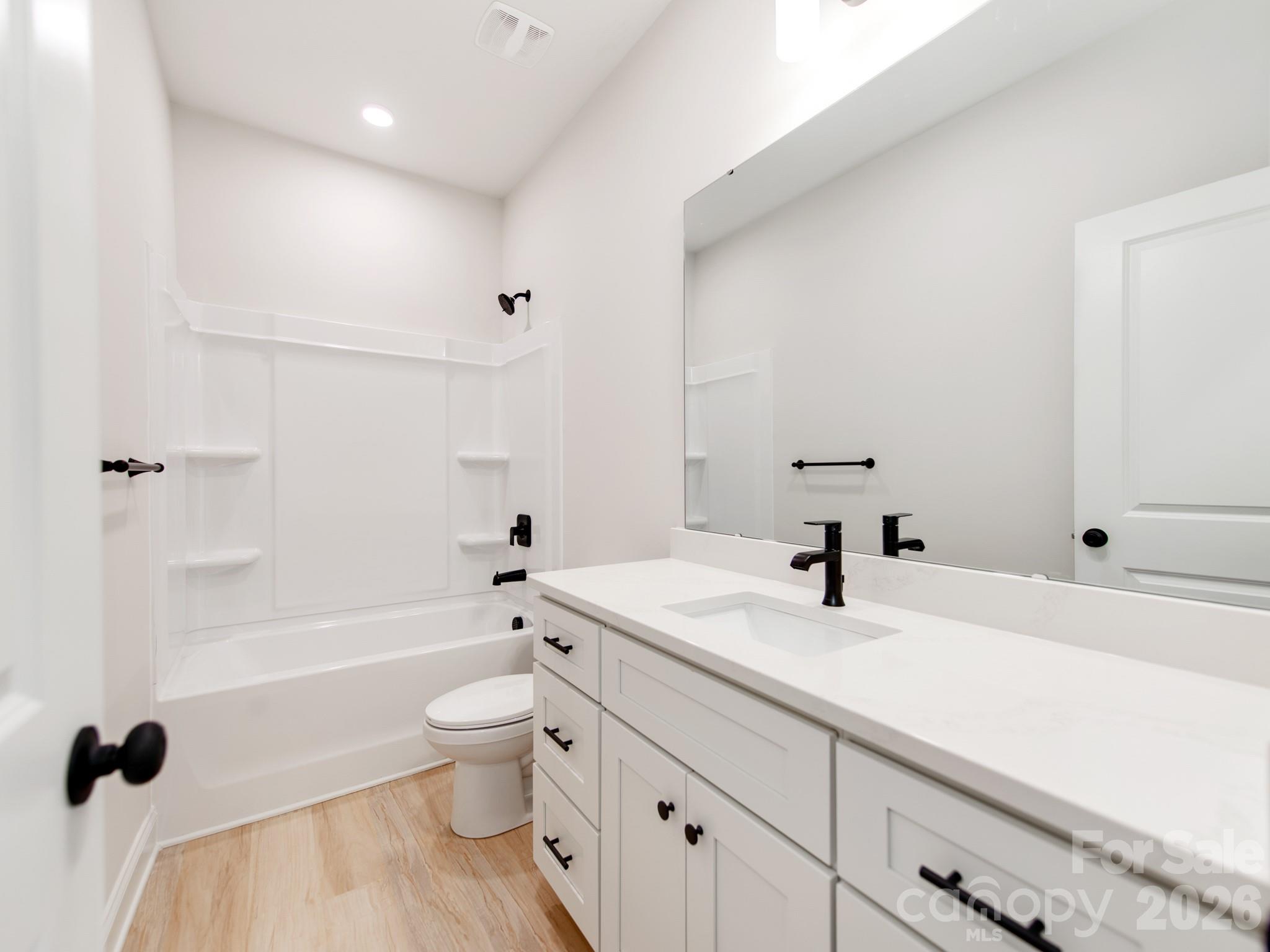 176 Whitetail Road Statesville, NC 28625 - Photo 19 of 23 a bathroom with a sink a toilet and a large mirror