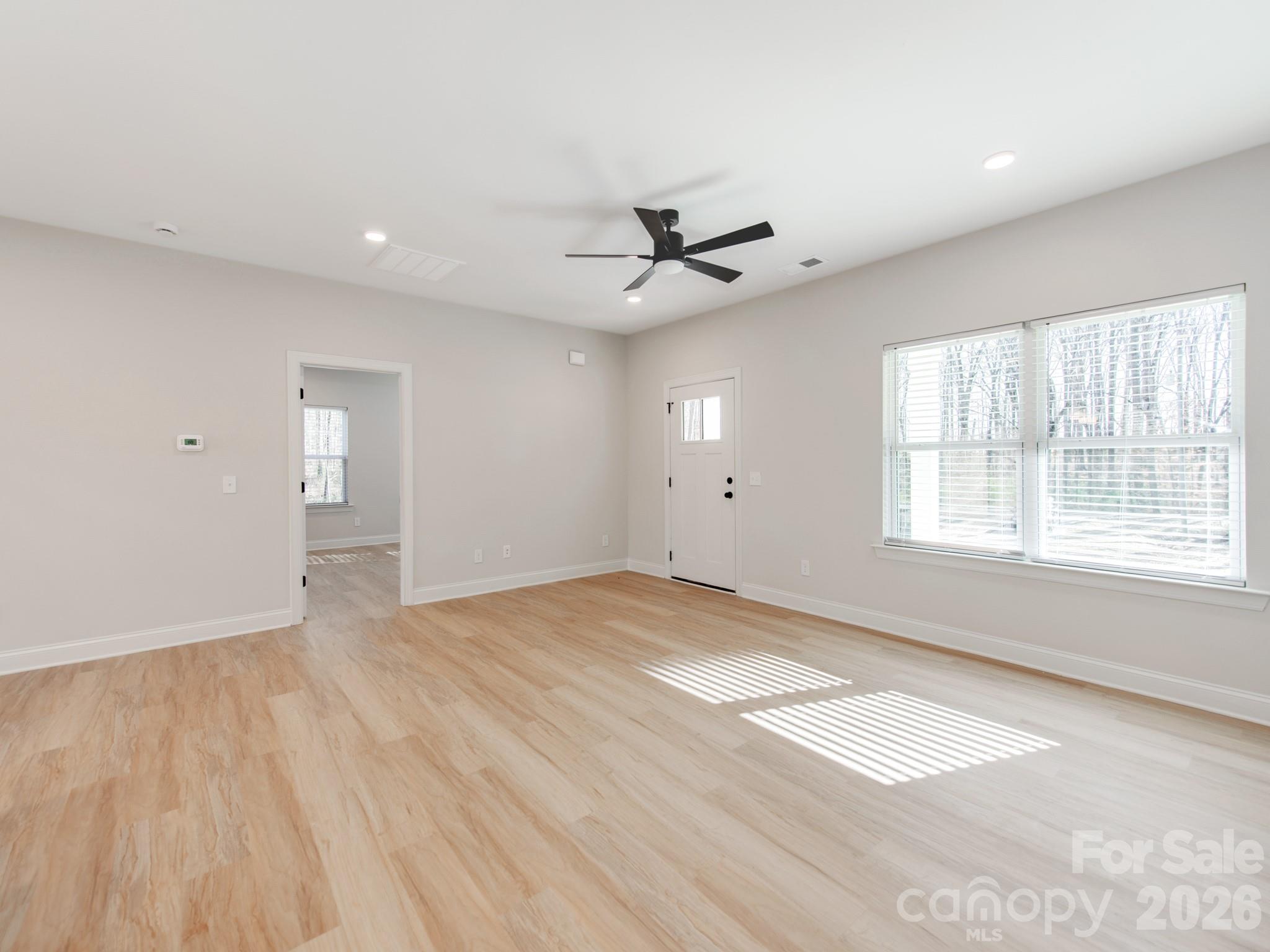 176 Whitetail Road Statesville, NC 28625 - Photo 6 of 23 wooden floor in an empty room with a window