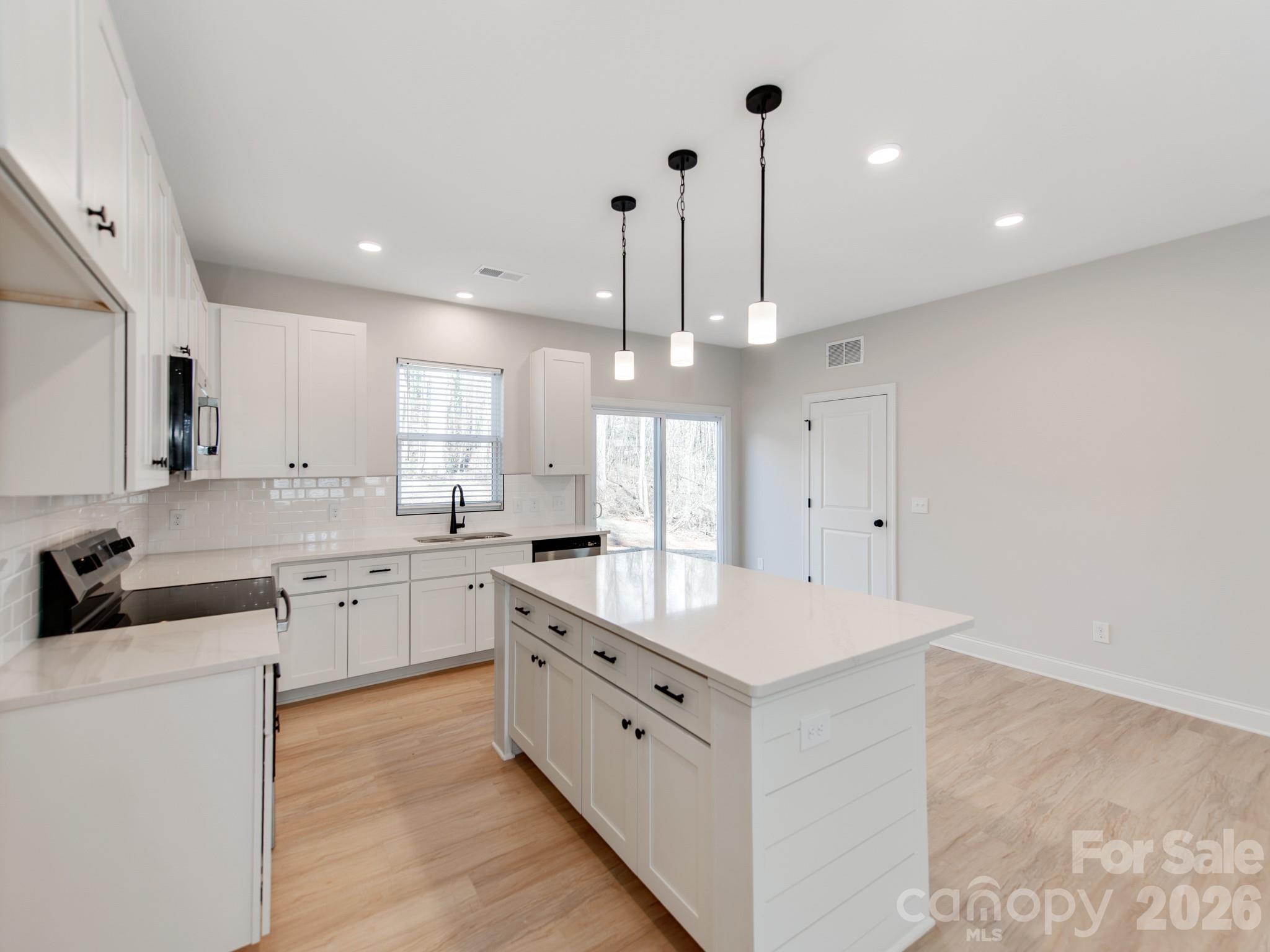 176 Whitetail Road Statesville, NC 28625 - Photo 9 of 23 a large white kitchen with cabinets