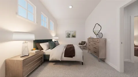 a spacious bedroom with a bed a mirror and lamp