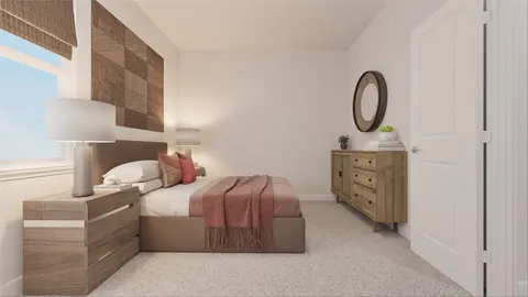 a spacious bedroom with a bed a couch and large window