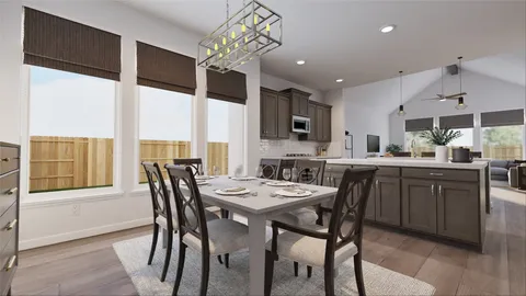 a kitchen with a dining table chairs and white cabinets