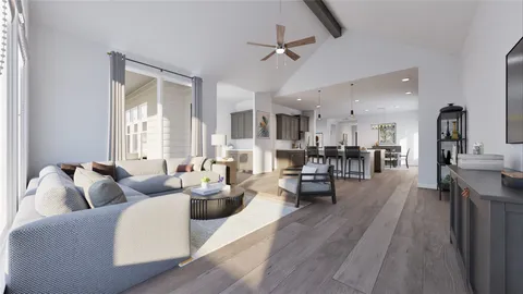a living room with furniture kitchen view and a wooden floor
