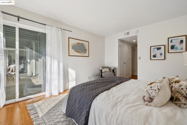 a bedroom with a bed and glass door