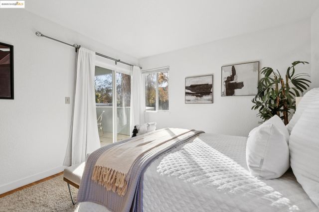 a bedroom with a large bed and a potted plant