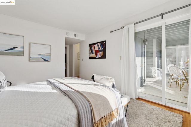 a bedroom with a large bed and a large window