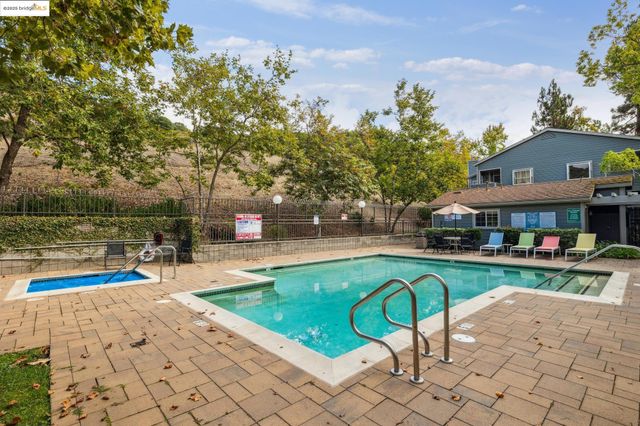 swimming pool view with a seating space