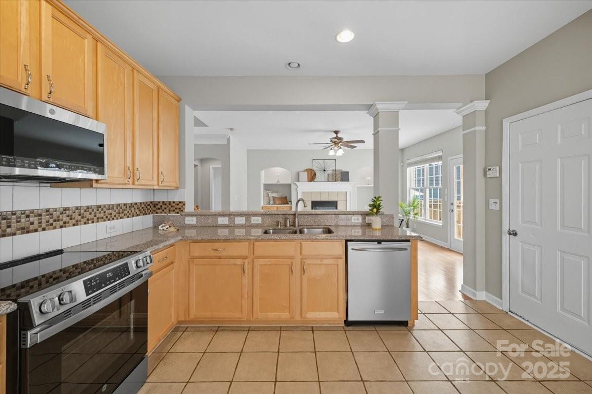17005 Carlton Way Road Huntersville, NC 28078 - Photo 16 of 45 a kitchen with a stove a sink and a microwave