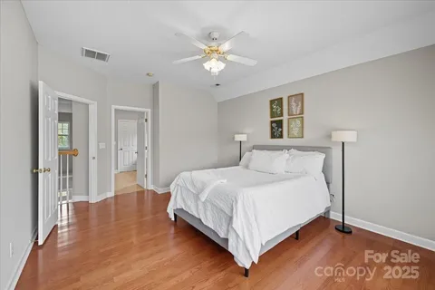 a bedroom with a large bed and a chandelier