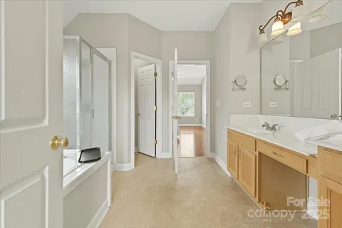 a large bathroom with a tub a sink and mirror