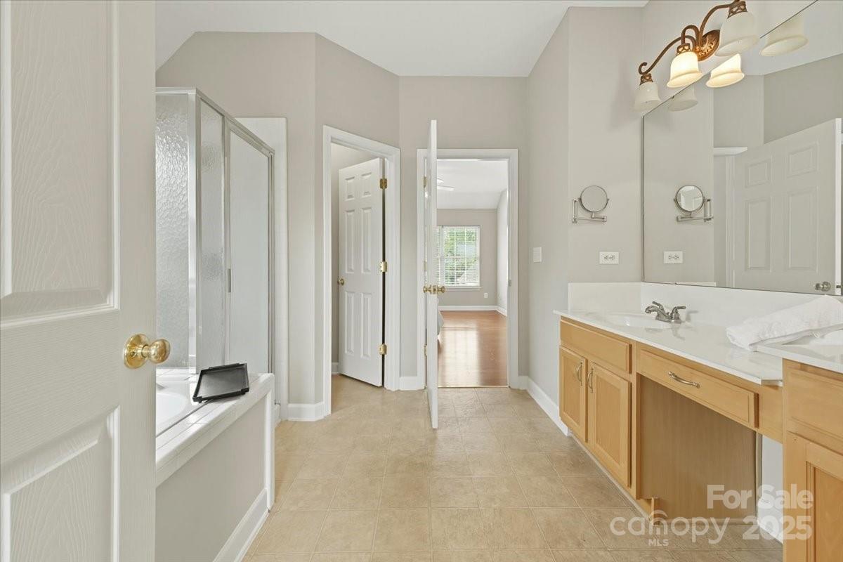 17005 Carlton Way Road Huntersville, NC 28078 - Photo 23 of 45 a large bathroom with a tub a sink and mirror