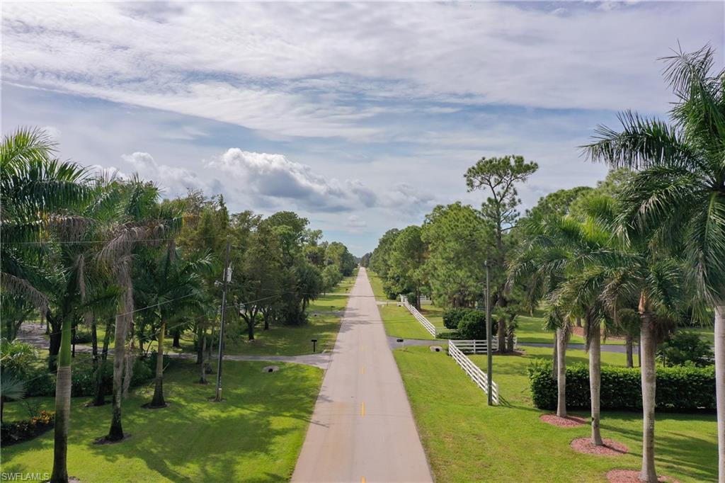 25 St Sw Naples Naples, FL 34117 - Photo 3 of 12 a view of a lake with a garden