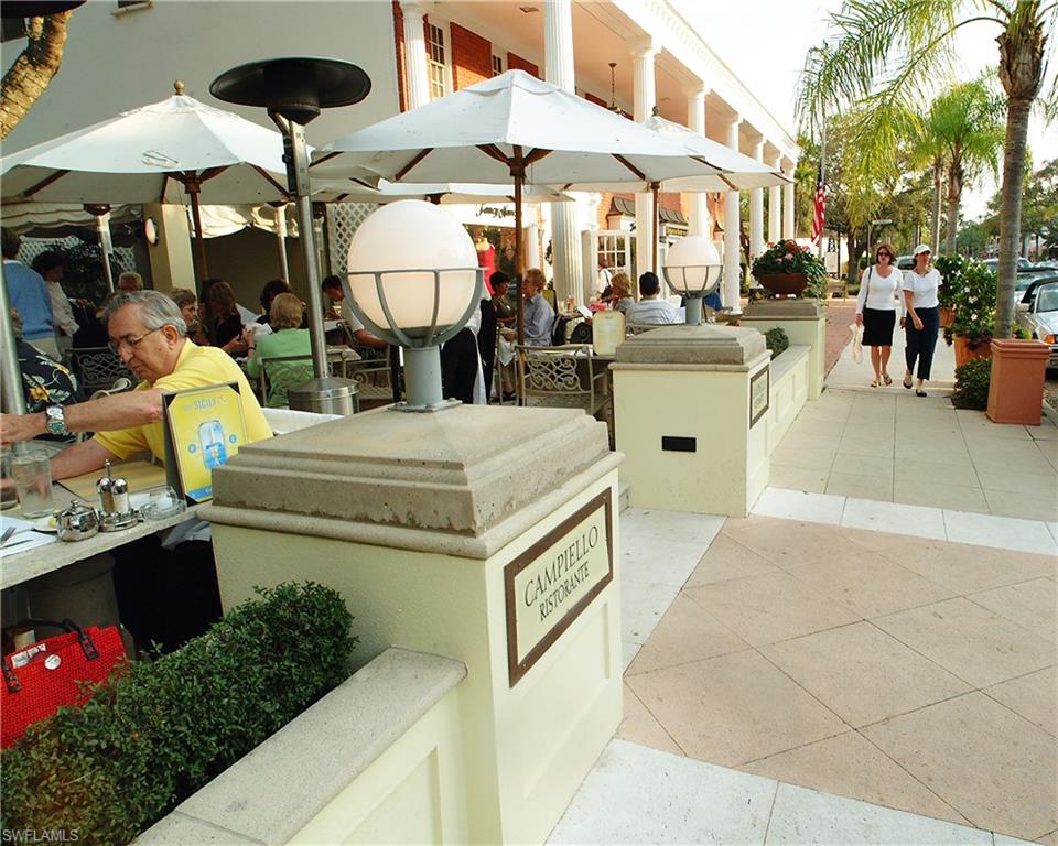 25 St Sw Naples Naples, FL 34117 - Photo 9 of 12 a view of a patio with chairs and umbrellas
