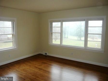 725 Milldam Road Towson, MD 21286 - Photo 14 of 21 a view of a room with wooden floor and windows