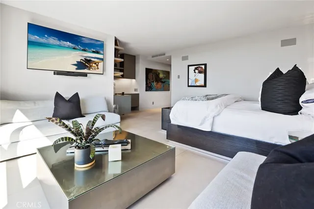 a bedroom with a bed couch and painting on the wall