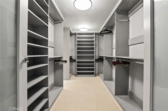 a view of walk in closet with empty racks