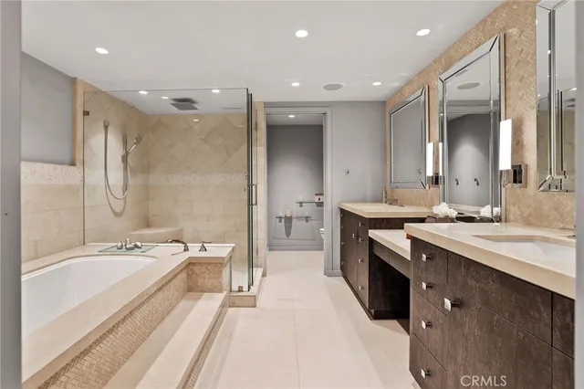a spacious bathroom with a bathtub shower sink double and mirror
