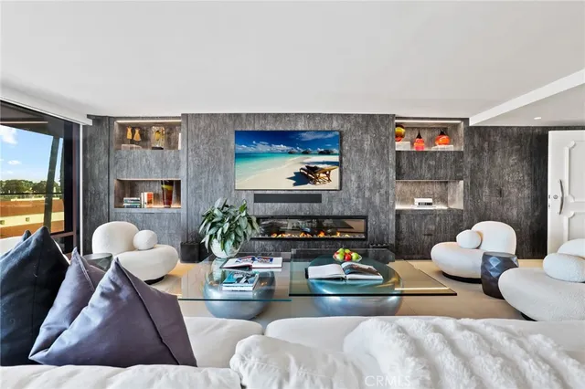 a living room with furniture fireplace and flat screen tv