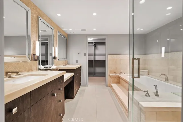 a large bathroom with a double vanity sink a large mirror and a shower
