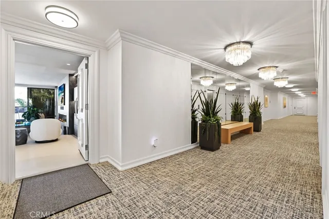 a view of a hallway and bedroom with furniture