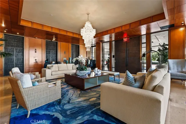 a living room with furniture and a chandelier