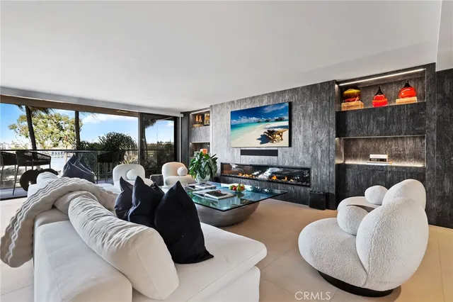 a living room with furniture kitchen view and a large window