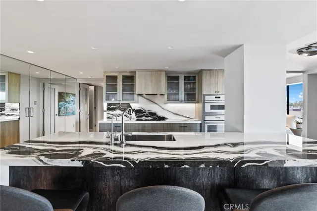 a living room with furniture kitchen and large window