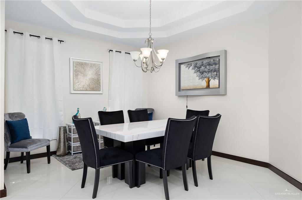 914 Rio Grande Drive Mission, TX 78572 - Photo 8 of 27 a view of a dining room with furniture and a chandelier