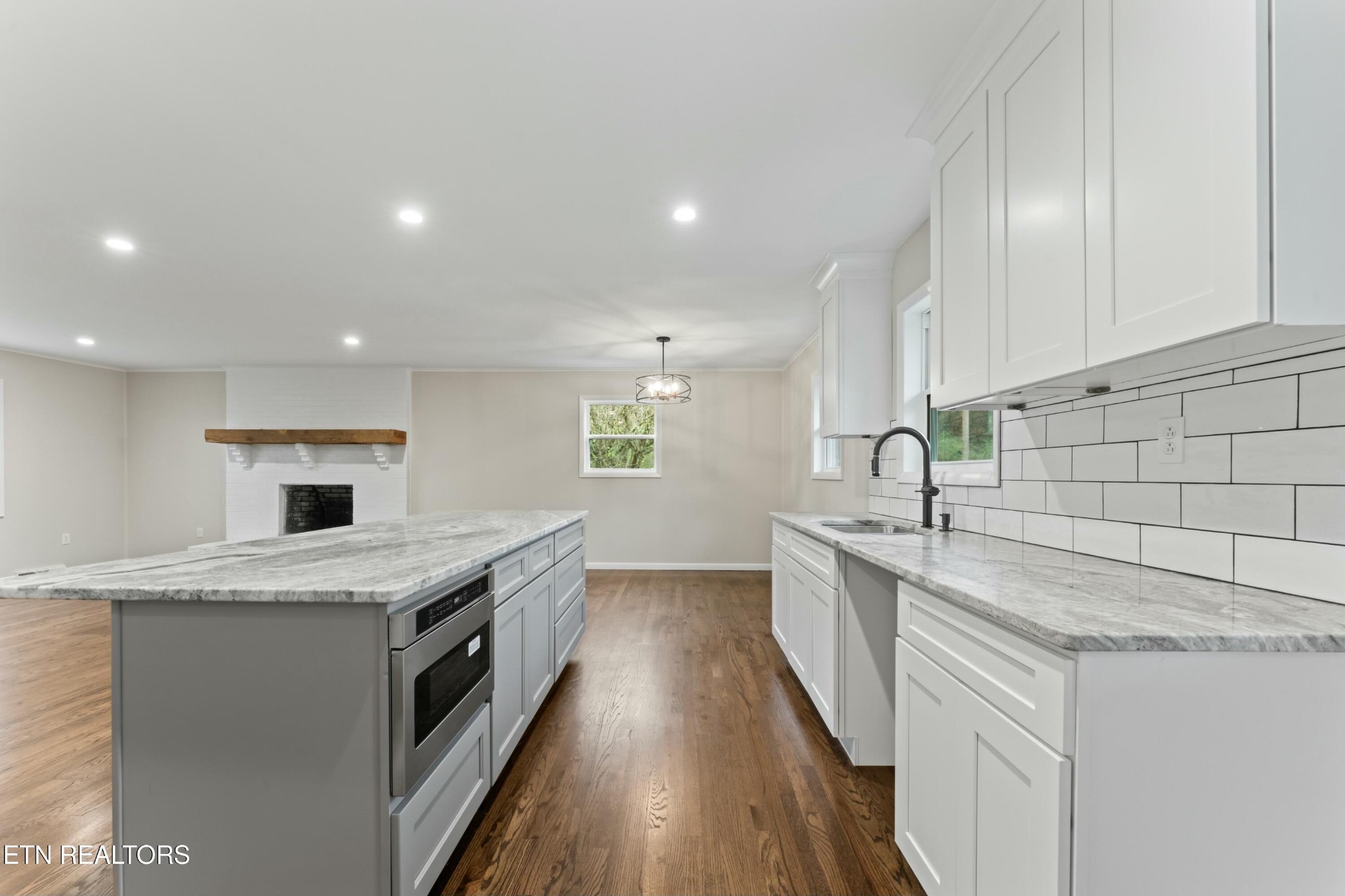 2229 Tooles Bend Road Knoxville, TN 37922 - Photo 13 of 41 a kitchen with granite countertop a sink stainless steel appliances and white cabinets