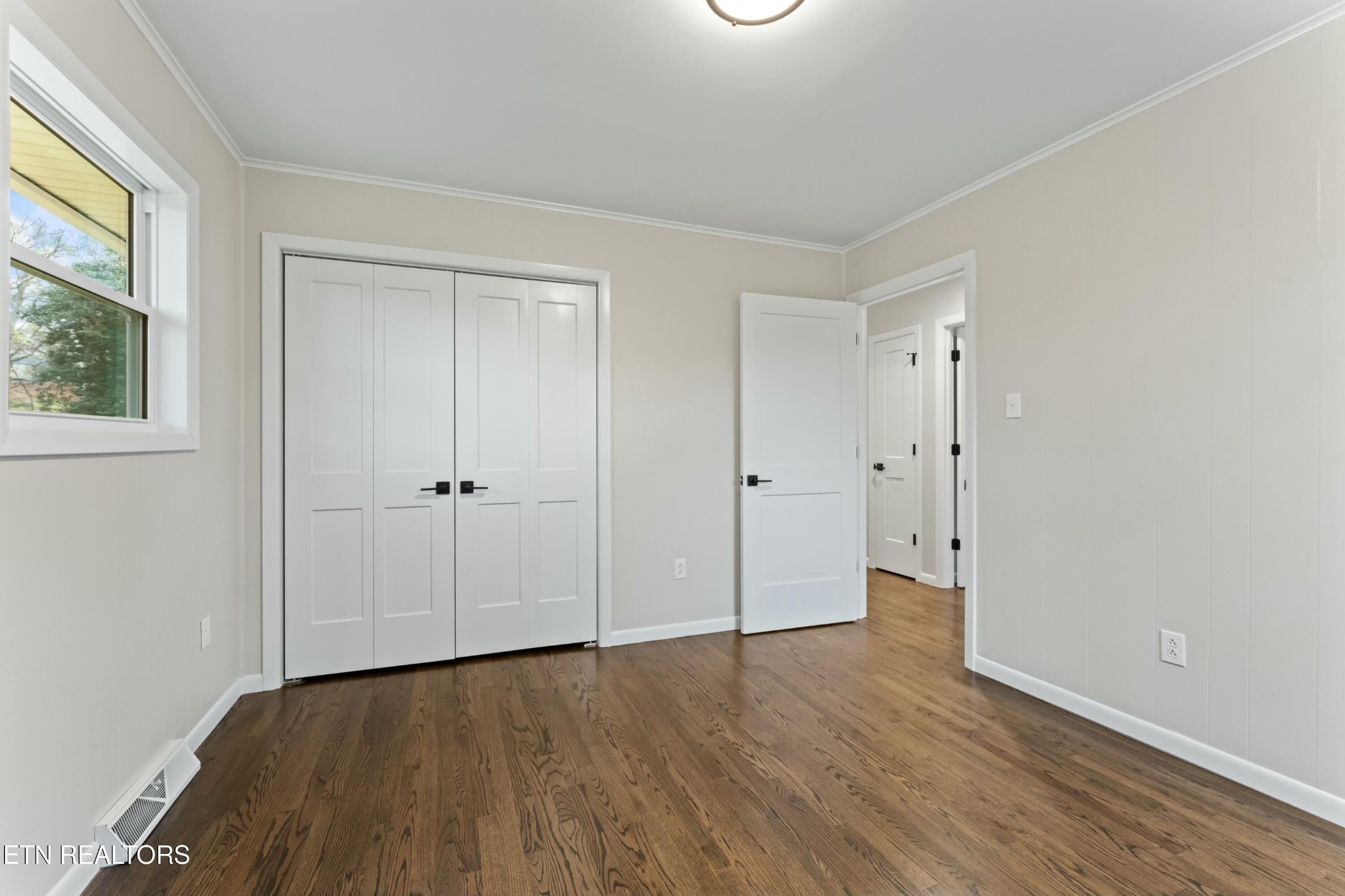 2229 Tooles Bend Road Knoxville, TN 37922 - Photo 21 of 41 a view of an empty room with wooden floor and a window