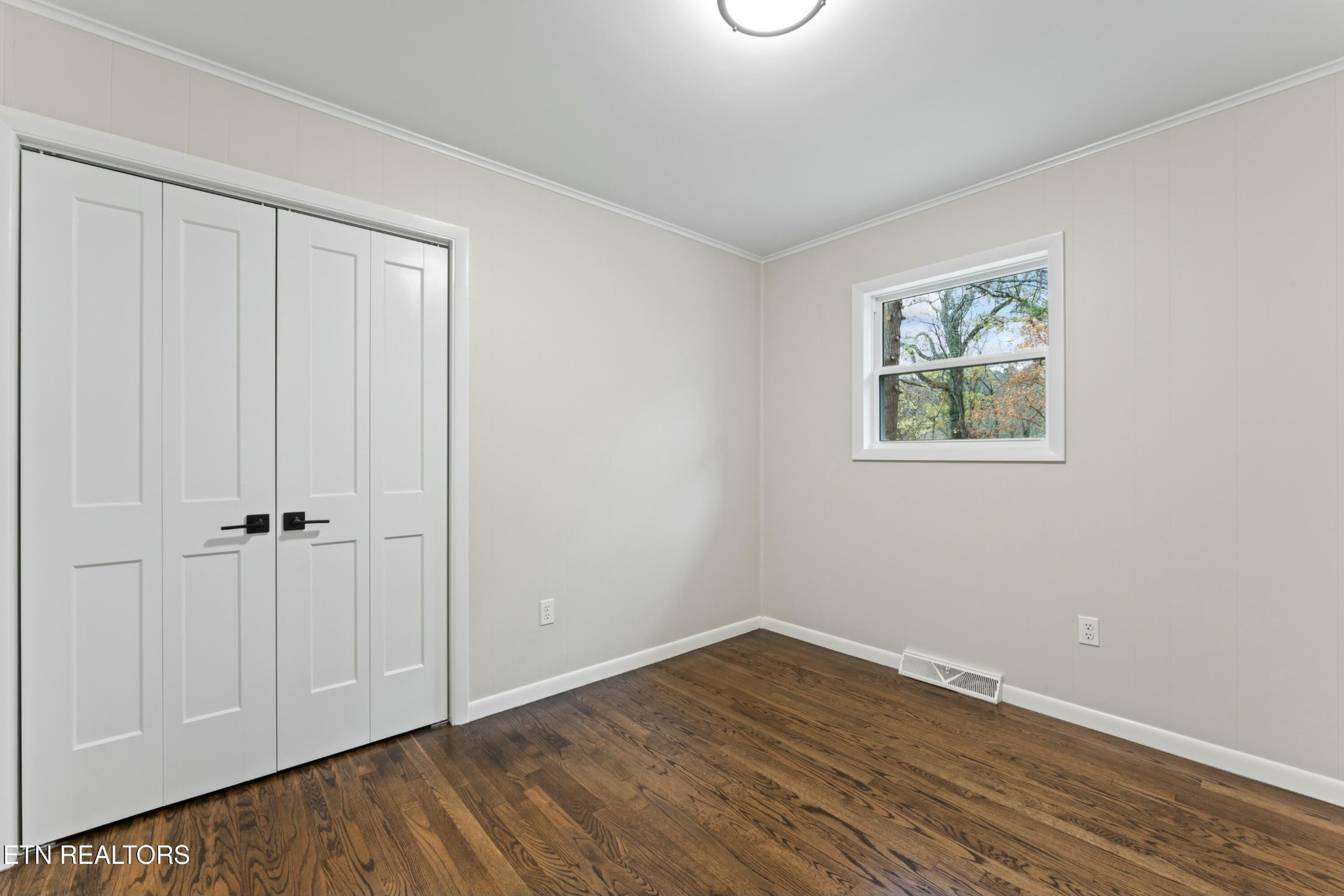 2229 Tooles Bend Road Knoxville, TN 37922 - Photo 23 of 41 a view of an empty room with wooden floor and a window