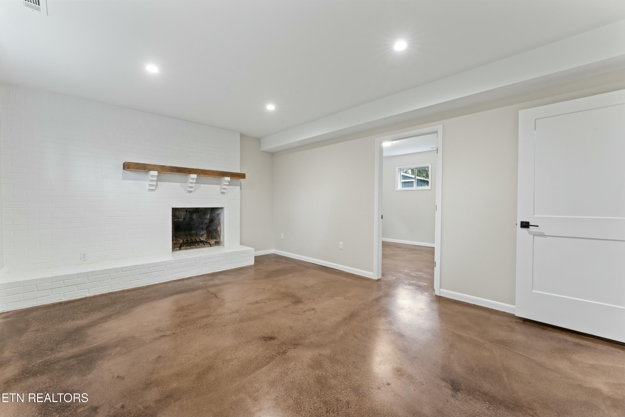 2229 Tooles Bend Road Knoxville, TN 37922 - Photo 26 of 41 an empty room with wooden floor and fireplace