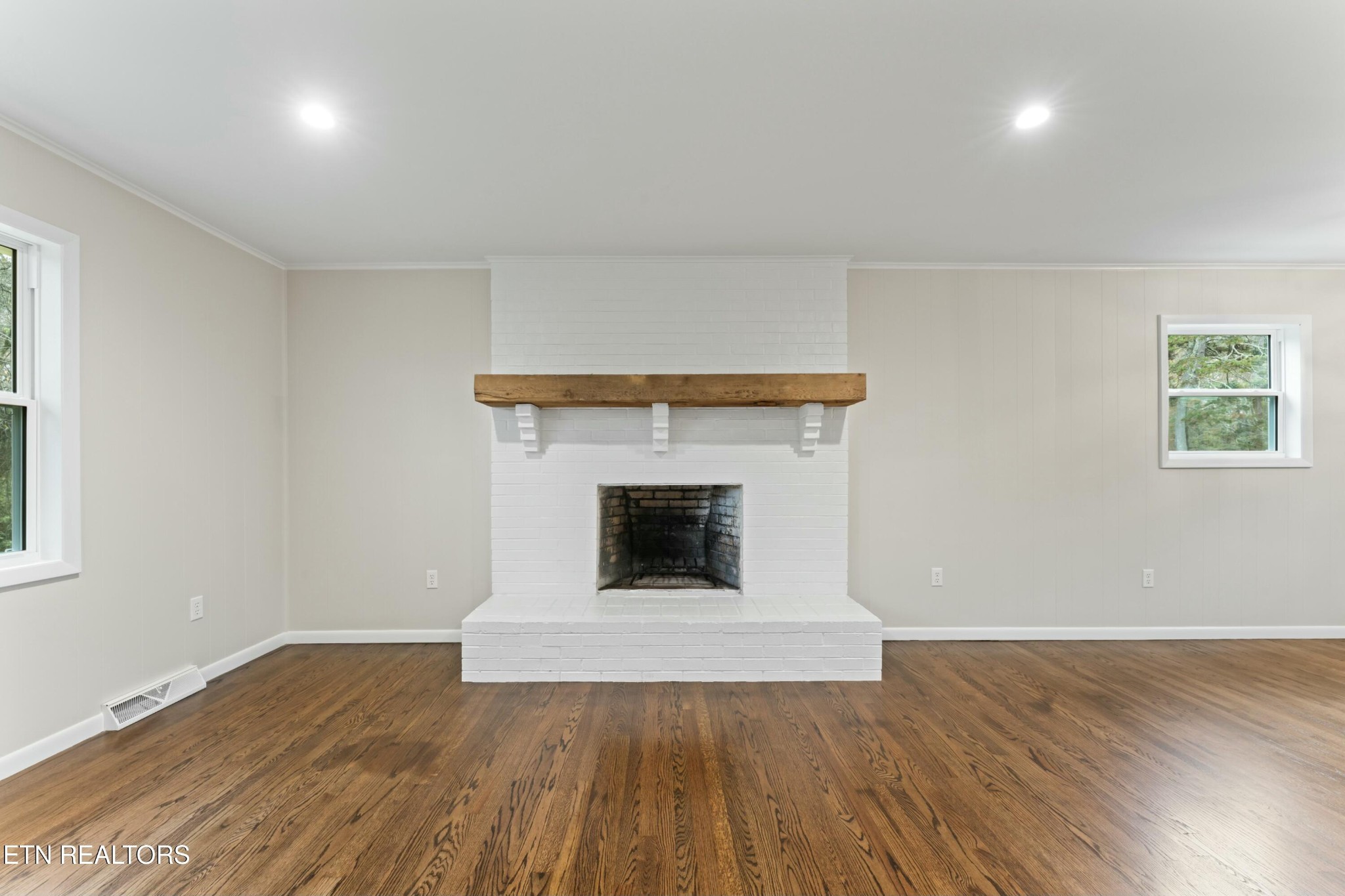 2229 Tooles Bend Road Knoxville, TN 37922 - Photo 9 of 41 an empty room with wooden floor and fireplace