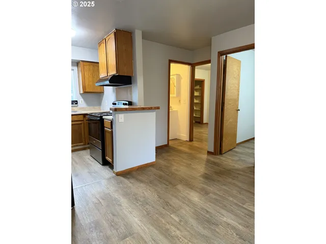 a kitchen with stainless steel appliances a stove top oven