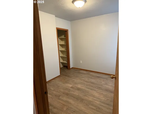 a view of an empty room with closet