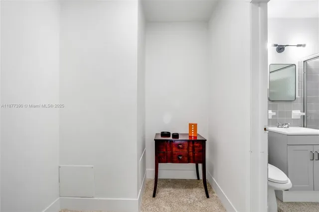 a bathroom with a toilet a sink and a mirror