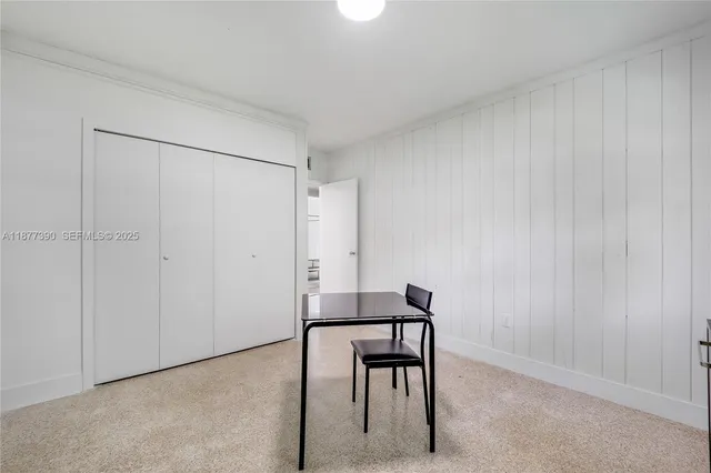 a bedroom with a bed and a mirror