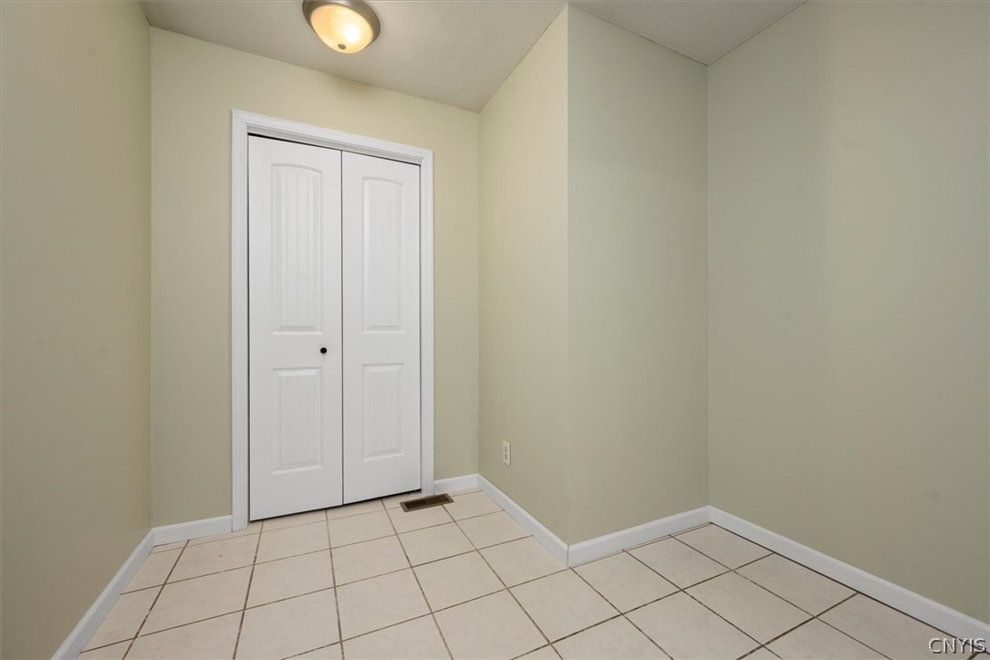 1322 Sawmill Road Sangerfield, NY 13480 - Photo 37 of 50 Durable tile flooring highlights this versatile utility space featuring a built-in storage closet.