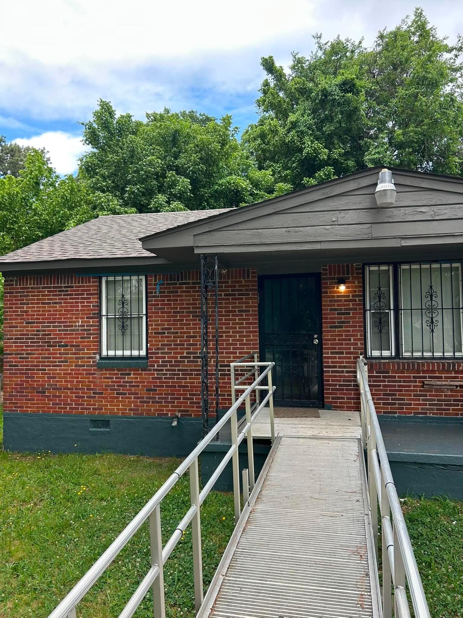 1510 Gausco Road Memphis, TN 38106 - Photo 1 of 10 Red brick exterior with a dark green foundation