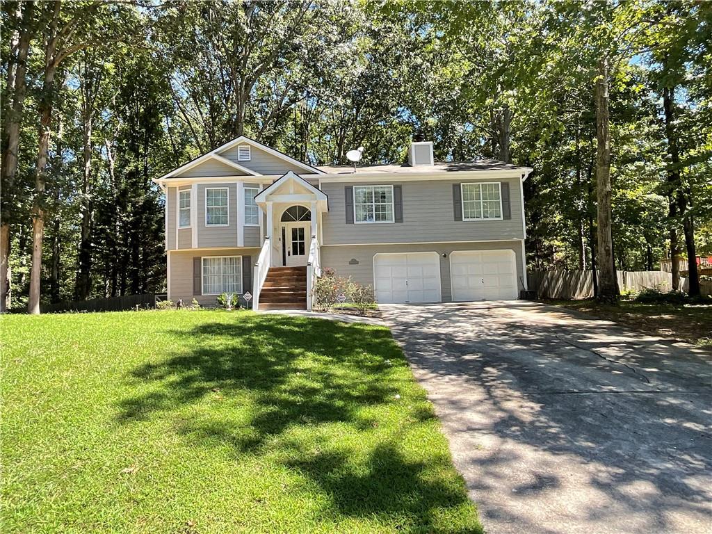 440 Briarwood Road Winder, GA 30680 - Photo 1 of 1 a front view of a house with a yard and garage