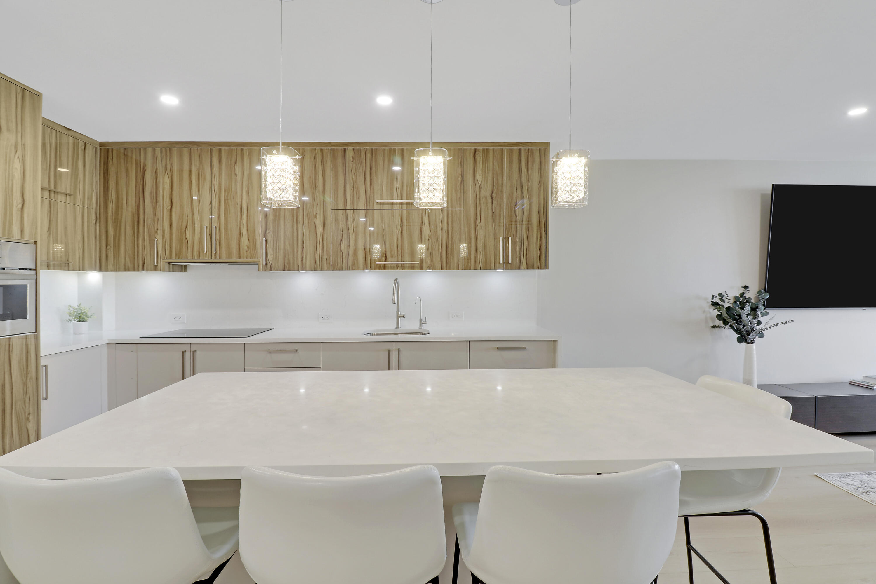 3540 South Ocean Boulevard, Unit 715 South Palm Beach, FL 33480 - Photo 1 of 39 a kitchen with a white cabinets a sink and a potted plant