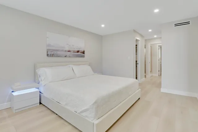 a large white bed in a white room