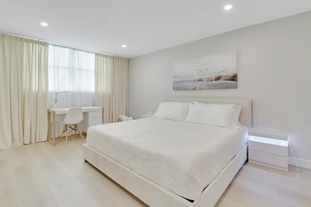 a large white bed in a white room